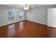 Bedroom featuring wood floors, ceiling fan, and two windows at 2722 Dodds Ln, Kissimmee, FL 34743