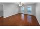 An empty bedroom with hardwood floors, two windows, a ceiling fan, and light gray walls at 2722 Dodds Ln, Kissimmee, FL 34743