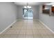 Bright dining room with tile flooring and chandelier, leads to outdoor patio at 2722 Dodds Ln, Kissimmee, FL 34743