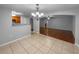 Open dining room with tile flooring and decorative chandelier flows into the living space at 2722 Dodds Ln, Kissimmee, FL 34743