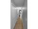 Neutral-colored hallway with tile floors, built-in storage, and decorative lighting at 2722 Dodds Ln, Kissimmee, FL 34743