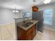 Bright kitchen featuring stainless steel refrigerator and granite countertops at 2722 Dodds Ln, Kissimmee, FL 34743