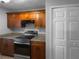 Well-equipped kitchen with wood cabinets, stainless steel appliances, and granite countertops at 2722 Dodds Ln, Kissimmee, FL 34743