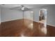 Open-concept living room with wood floors and seamless flow into the kitchen and dining areas at 2722 Dodds Ln, Kissimmee, FL 34743