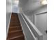 Staircase with wooden steps and white banister leading upstairs at 2722 Dodds Ln, Kissimmee, FL 34743