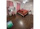 Bright bedroom with a bed, vanity table, and wood floors at 2831 S M U Blvd, Orlando, FL 32817