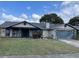 Charming one-story home featuring a spacious front yard with a decorative fountain at 2831 S M U Blvd, Orlando, FL 32817
