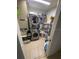 Cozy laundry area featuring a stacked washer and dryer and shelving at 2831 S M U Blvd, Orlando, FL 32817