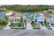 Expansive aerial view showcases the home's location near a serene pond and lush greenery at 3320 Grande Heron Dr, Harmony, FL 34773