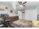 Bedroom with wood floors featuring ceiling fan, and closet space at 3320 Grande Heron Dr, Harmony, FL 34773