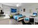 Cozy bedroom with wood floors, ceiling fan, and a large window for natural light at 3320 Grande Heron Dr, Harmony, FL 34773