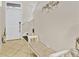 Inviting foyer with tiled flooring, a decorative bench, and stairway access to the upper level at 3320 Grande Heron Dr, Harmony, FL 34773