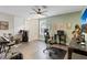 Spacious living room with laminate floors, entertainment area, and ceiling fan at 3320 Grande Heron Dr, Harmony, FL 34773