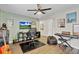 Relaxing living room with a ceiling fan, comfortable bean bag chair, and entertainment area at 3320 Grande Heron Dr, Harmony, FL 34773