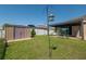 A spacious backyard featuring a shed, gazebo, well-maintained lawn, a covered patio, and privacy fencing at 3797 Briarwood Estates Cir, St Cloud, FL 34772