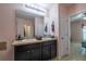 Bathroom with double vanity, granite countertops, and view to bedroom at 3797 Briarwood Estates Cir, St Cloud, FL 34772