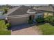 Beautiful single-story home featuring a well-manicured lawn, brick driveway, and cozy front entrance at 3797 Briarwood Estates Cir, St Cloud, FL 34772