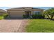 Charming single-story home featuring a well-manicured lawn, brick driveway, and cozy front entrance at 3797 Briarwood Estates Cir, St Cloud, FL 34772
