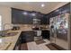 Kitchen with stainless steel appliances, granite counters, and dark cabinets at 3797 Briarwood Estates Cir, St Cloud, FL 34772