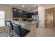 Kitchen with breakfast bar, granite counters, and dark cabinetry at 3797 Briarwood Estates Cir, St Cloud, FL 34772