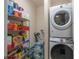 Laundry room with washer, dryer, storage shelving and bottled water at 3797 Briarwood Estates Cir, St Cloud, FL 34772
