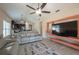 Bright living room with ceiling fan, tile floors, leather sofas, and TV area at 3797 Briarwood Estates Cir, St Cloud, FL 34772