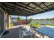 View of the covered patio with string lights, outdoor seating, and a glimpse of the backyard, and above ground pool at 3797 Briarwood Estates Cir, St Cloud, FL 34772