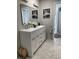 Spacious bathroom featuring a dual sink vanity with large mirrors and contemporary lighting at 4938 Samoa Cir # 6, Orlando, FL 32808