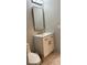 Modern bathroom featuring a white vanity with gold fixtures and a matching framed mirror at 4938 Samoa Cir # 6, Orlando, FL 32808