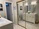 An open bathroom design with dual vanities with plenty of storage and large mirrors at 4938 Samoa Cir # 6, Orlando, FL 32808