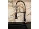 Close-up of a modern black faucet with gold accents at 4938 Samoa Cir # 6, Orlando, FL 32808
