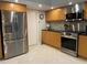 Spacious kitchen with stainless steel appliances and tile flooring at 4938 Samoa Cir # 6, Orlando, FL 32808