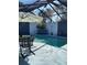A view of the screened pool and patio area with comfortable seating, a flamingo statue, and sun protection at 4938 Samoa Cir # 6, Orlando, FL 32808