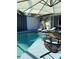 Exterior view of the screened-in pool, with lounge chairs, a bistro table, and access to the house at 4938 Samoa Cir # 6, Orlando, FL 32808
