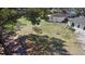 Aerial view of fenced backyard with grass, mature trees, and shed at 509 Nicole Blvd, Ocoee, FL 34761