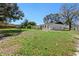 Spacious fenced backyard with mature trees and grass at 509 Nicole Blvd, Ocoee, FL 34761