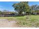 Fenced backyard with mature trees and grass at 509 Nicole Blvd, Ocoee, FL 34761