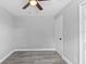 Neutral bedroom featuring wood-look floors, ceiling fan, and closet with white trim at 509 Nicole Blvd, Ocoee, FL 34761