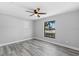 Bedroom with vinyl floors, neutral paint, ceiling fan, and a large window at 509 Nicole Blvd, Ocoee, FL 34761