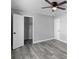 Neutral bedroom features vinyl flooring, ceiling fan, and closet at 509 Nicole Blvd, Ocoee, FL 34761