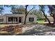 Inviting single-story home with tidy front yard, mature tree and driveway leading to a detached garage at 509 Nicole Blvd, Ocoee, FL 34761