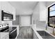 Updated kitchen with stainless steel appliances, ample counter space, and gray wood flooring at 509 Nicole Blvd, Ocoee, FL 34761