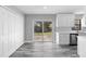 Bright kitchen features white cabinets, stainless steel appliances, and sliding glass door to yard at 509 Nicole Blvd, Ocoee, FL 34761