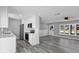 Stylish kitchen with stainless steel appliances, gray flooring, and a layout that flows into the living spaces at 509 Nicole Blvd, Ocoee, FL 34761