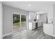 Open-concept kitchen featuring stainless steel appliances, a bright window, and seamless flow to the living area at 509 Nicole Blvd, Ocoee, FL 34761