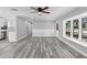 Bright living room features vinyl plank flooring, chair rail accent, and a large window overlooking the yard at 509 Nicole Blvd, Ocoee, FL 34761