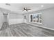 Open living room with vinyl floors, neutral paint, chair rail, and a view of the front yard at 509 Nicole Blvd, Ocoee, FL 34761