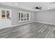 Living room with vinyl floors, neutral paint, ceiling fan, and a large bay window at 509 Nicole Blvd, Ocoee, FL 34761