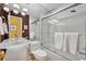 Bright bathroom with a glass shower door, unique lighting, and towel racks at 535 N Interlachen Ave # 107, Winter Park, FL 32789