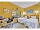Bright bedroom with two twin beds, a work space, and a window overlooking foliage at 535 N Interlachen Ave # 107, Winter Park, FL 32789